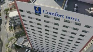 a large white building with a sign on the side of it at Comfort Hotel Goiânia in Goiânia