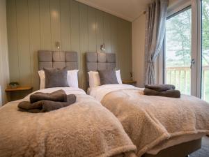 Ένα ή περισσότερα κρεβάτια σε δωμάτιο στο Otter Lodge