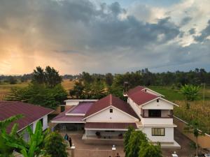 an overhead view of a building with a rainbow in the background at Kilimanjaro Lyimo's Country House2 in Moshi