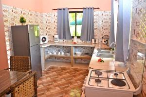 a kitchen with a stove and a sink at My Angel in La Digue