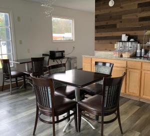 a dining room with a black table and chairs at Travelodge by Wyndham Walterboro in Walterboro