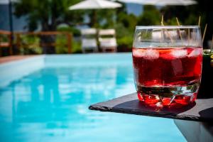 a drink sitting on a table next to a swimming pool at B&B Casabianca Palinuro in Palinuro +47 photos