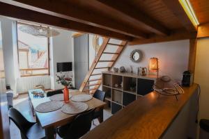 a dining room with a table and a staircase at ROYALEMENT BIEN ! Hyper-centre - Wifi - Vieille Ville in Annecy