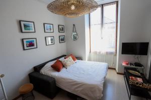 a bedroom with a bed with pillows on it at ROYALEMENT BIEN ! Hyper-centre - Wifi - Vieille Ville in Annecy