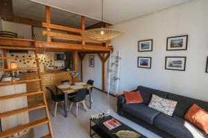 a living room with a couch and a loft bed at ROYALEMENT BIEN ! Hyper-centre - Wifi - Vieille Ville in Annecy