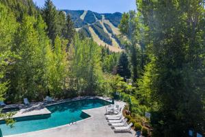 an aerial view of a swimming pool with trees and mountains at Prospector 134 in Ketchum