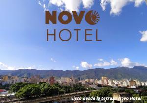 a sign that reads novo hotel with a city at Novo Hotel in Caracas