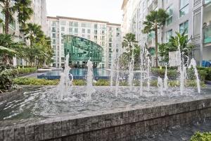 a fountain in the middle of a city with buildings at TRENDY Studio in City Center Residence in Pattaya