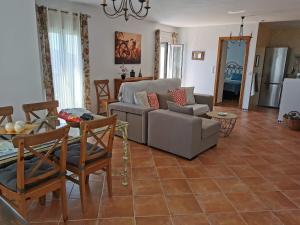 a living room with a couch and a table at Casa Ayo in Frigiliana