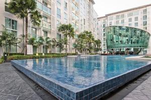a large swimming pool in the middle of a building at TRENDY Studio in City Center Residence in Pattaya