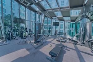 a gym with cardio equipment in a building at TRENDY Studio in City Center Residence in Pattaya