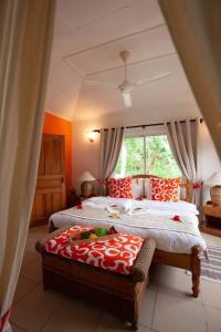 a bedroom with two beds and a large window at Oceane L'union Villa in La Digue
