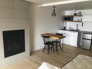 a kitchen with a table and chairs and a fireplace at 378 Marine Drive in Ucluelet