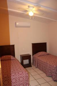 Postel nebo postele na pokoji v ubytování Hotel Boutique Real Tequila