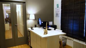 a room with a desk with a computer and a cat statue on it at Hostal El Ninot in Barcelona