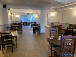 a dining room with tables and chairs in a restaurant at Castle Hotel in Devizes +32 photos