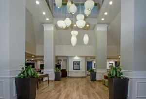 a lobby with white columns and potted plants at Shutters Hotel in Elko +133 photos
