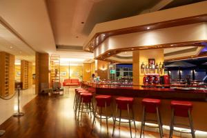 a bar at a restaurant with red stools at Athineon Hotel in Rhodes Town