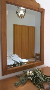 a mirror on top of a wooden table at Pleiades Apartments in Lefkos Karpathou