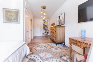 a bedroom with a bed and a table and a tv at The Bishop Arts Hotel by Qresorts in Dallas +76 photos