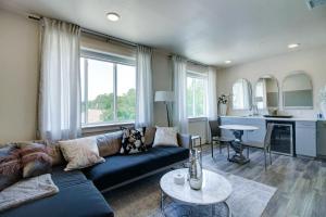 a living room with a blue couch and a kitchen at The Bishop Arts Hotel by Qresorts in Dallas