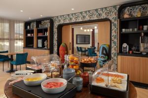 a kitchen with a table with food on it at Les Nomades Beaune in Beaune