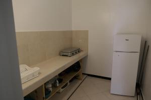 a kitchen with a counter with a white refrigerator at Le Calme a Temara in Temara