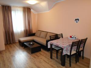 a living room with a couch and a table at Studio D-55 in Borovets Gardens hotel in Borovets