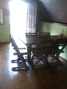 a wooden table and chairs in a room at Chalet da vila in Angra dos Reis