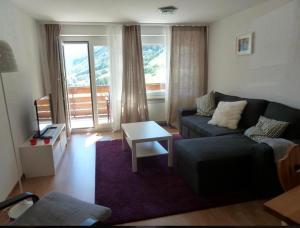 a living room with a couch and a table at Eldorado 44 in Leukerbad