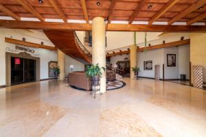 a large lobby with a wooden ceiling and a staircase at Hotel Ruinas Resort in Huehuetenango