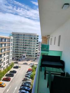 einen Balkon mit Blick auf einen Parkplatz mit Autos in der Unterkunft Seven Luxury in Mamaia Nord – Năvodari