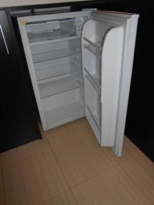 an empty refrigerator with its door open in a kitchen at Studio D-55 in Borovets Gardens hotel in Borovets