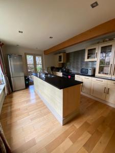a kitchen with a large island in the middle at The Stables, Ulverston in Ulverston