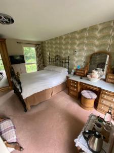 a bedroom with a bed and a large mirror at The Stables, Ulverston in Ulverston