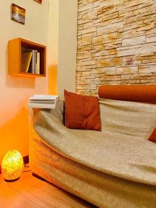 a bed in a room with a stone wall at Casa Vacanze La Casetta in Lido di Ostia