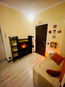 a living room with a couch and a fireplace at Casa Vacanze La Casetta in Lido di Ostia