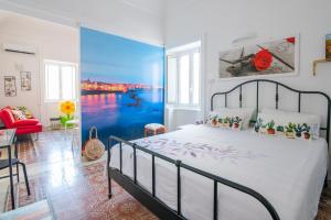 a bedroom with a bed with a blue wall at Casa Dreaming Ortigia in Siracusa