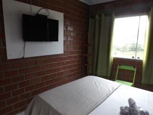 En eller flere senge i et værelse på Pousada Monte Serrat