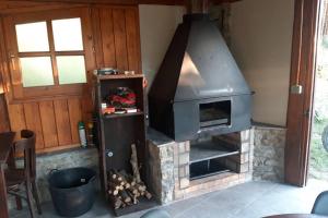 a fireplace in a living room with a stove at Casa en entorno natural , registro HUT6-00-7741 in Sant Julià de Lòria
