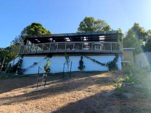 a deck on the side of a house with trees at Stella the Excella in Russell