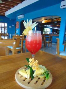 a plate of food with a drink on a table at Hotel Pez Vela in Manzanillo