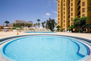 a large swimming pool in front of a building at Tenerife Costa Adeje Apartment in Playa Fañabe
