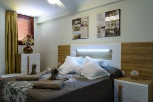 a bedroom with a bed with two pillows on it at Tenerife Costa Adeje Apartment in Playa Fañabe