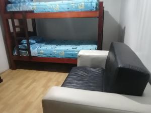 a living room with a couch and bunk beds at Escocie - Centro Historico in Quito +7 photos