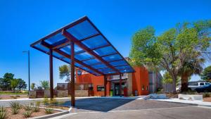 a building with a large glass canopy in a parking lot at Best Western El Paso Airport Entrada Hotel in El Paso