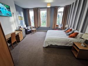 a bedroom with a large bed and a living room at Aspire 860 in Colchester