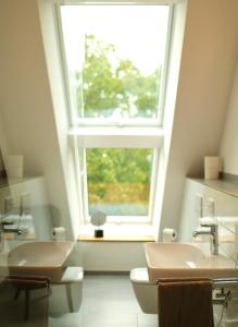 a bathroom with a sink and a window at Hausdeich in Hamburg