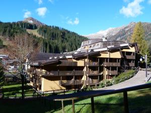 a large building in the middle of a mountain at Monolocali Alberti - Des Alpes in Madonna di Campiglio