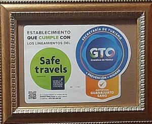 a framed picture of a sign for safe travels at Casa Bertha in Guanajuato